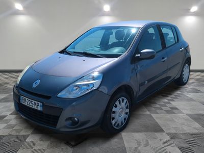 the small blue car is parked in a room with a checkered floor