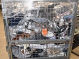 a metal cart filled with bottles and cans in a warehouse