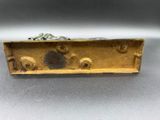 an image of a metal object with a frog on it