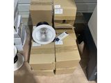 a pile of boxes and a fan on the floor