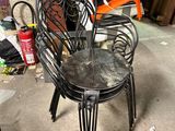 a black chair that is sitting in the middle of a room