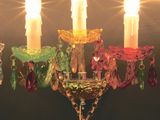 a chandelier that has five candles on it