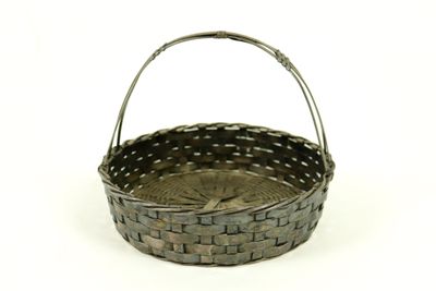 a small basket with a handle on a white surface
