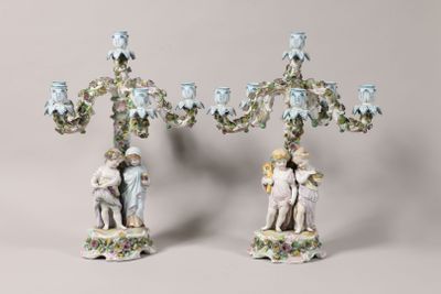 pair of porcelain figurines of a boy and a girl on a tree
