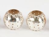 three silver vases sitting next to each other on a white surface