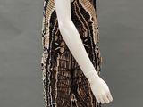 a black and gold beaded dress on a mannequin mannequin