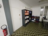 a room with a book shelf and a fire extinguisher
