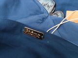 a label on the back of a woman ' s blue dress