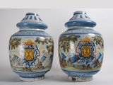 pair of blue and white vases with a coat of arms on them