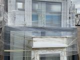 a picture of a house with a lot of windows wrapped in plastic