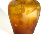 a yellow vase sitting on a table with a white background