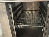 an open oven that is sitting inside of a kitchen