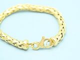 a gold bracelet on a blue background