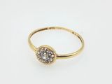 a gold ring with a white diamond in the center