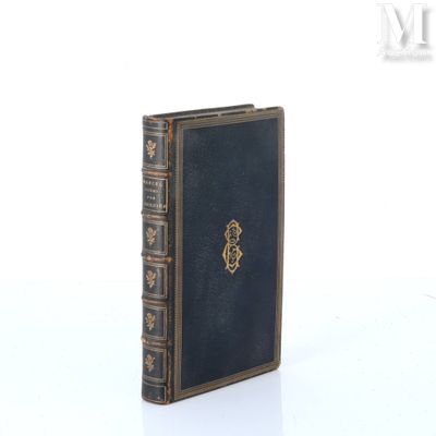 an old book sitting on top of a white table next to a white wall