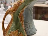 two vases that are sitting on a table