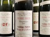 several bottles of wine are lined up on a table