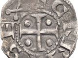 an old silver coin with a cross on it on a white background