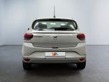 the rear end of a silver car in a white room