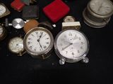 many different types of clocks sitting on a table