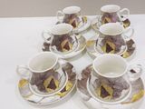 six cups and saucers sitting on a white table