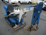 an image of a small blue and white machine in a parking lot