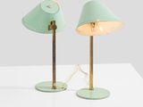 a pair of green lamps on a white table