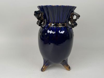 a blue vase that is sitting on a table