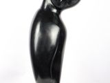 sculpture of a black bird on a white pedestal