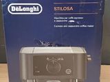 packaging of a delonghi coffee machine sitting on a wooden table