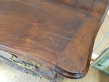 a wooden table with a drawer underneath it on a hard wood floor