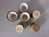 several cups with lids are arranged in a circle on a table