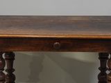 an old wooden table with a drawer on top of it