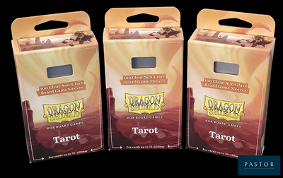 three boxes of tarot sitting on top of each other on a black surface