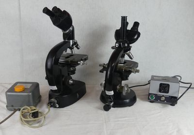 two microscopes that are sitting next to each other