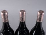 three bottles of wine that are sitting on a table