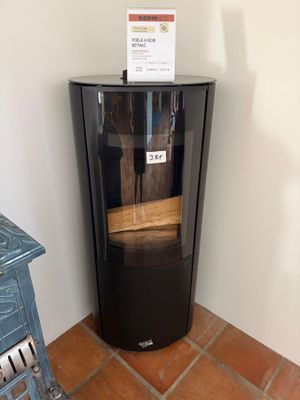a small black cabinet with a sign on top of it
