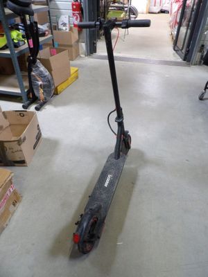 a scooter that is sitting on the floor in a store