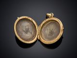 two gold lockes with a picture of a woman and a man inside