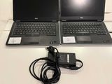 two laptops that are sitting on a table