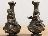 two vases that are sitting on a table