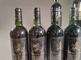 several bottles of wine are lined up on a table