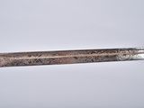 a close up of a knife on a table with a white background