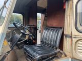 a seat in the back of a truck with a steering wheel