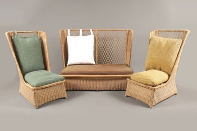 trois chaises en osier avec des coussins et un oreiller sur fond gris