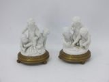 pair of white marble figurines of children playing with a ball