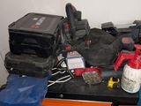 a pile of tools sitting on top of a workbench