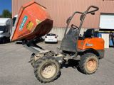 a tractor with a dumper attached to it in a parking lot