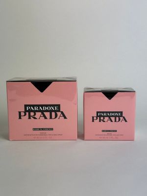 a pair of pink prada boxes sitting on top of a white table
