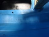 a close up of a blue container with a hole in it